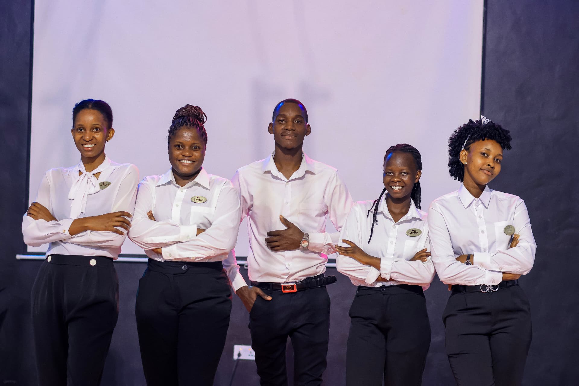Roi Agency ushering team in white shirts standing together at an event venue
